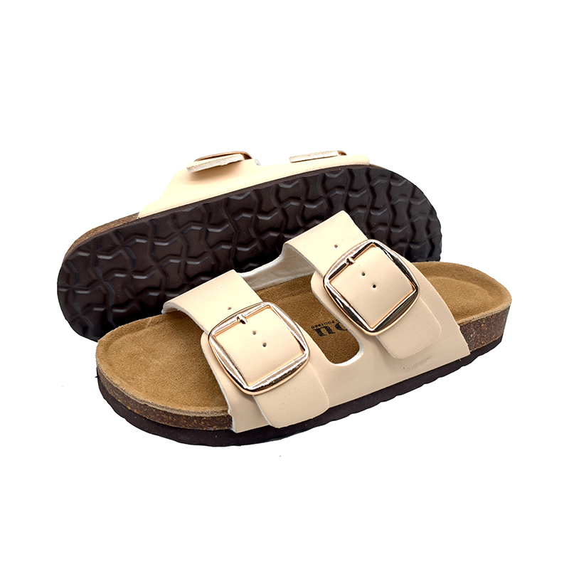 Unisex cork slide sandals with cream PU straps, double metal buckles, and textured outsole